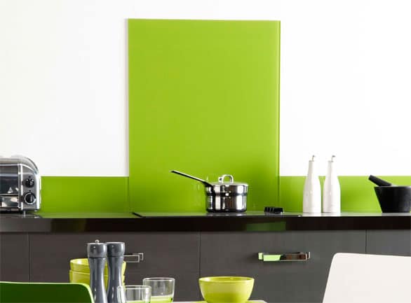 Bright green glass splashback behind a hob